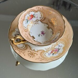 antique gold colored English bone china teacup and saucer by Coalport